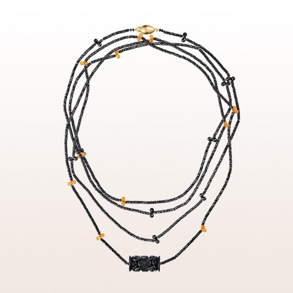 Necklace with carved onyx, black spinel, mandarin garnet and an 18kt yellow gold clasp