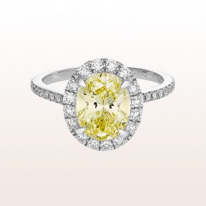 Ring with oval fancy intense-yellow diamond 1,84ct and brilliant cut diamonds 0,50ct in 18kt white gold